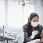 Dental hygienist cleaning a woman's teeth 