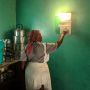 Woman presses wall device that lights up