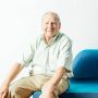 Hal Abelson sitting in a blue chair with a white background 