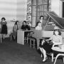 Black and white image from 1940s of women relaxing in a room with a piano