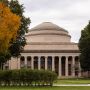 A photo of MIT's Killian Court with the Great Dome in the center of the image and trees surrounding