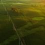 Aerial shot of powerlines and grass fields.