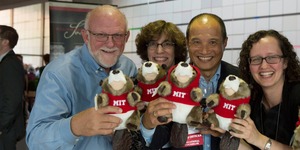 MIT alumni holding stuff animal mascots "Tim the Beaver" 