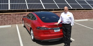 Jim Smith '69 with his electric car and solar panels.