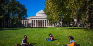 Killian court at MIT with 3 students in masks 