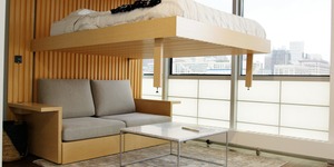 Bed lowering from the ceiling over a couch 