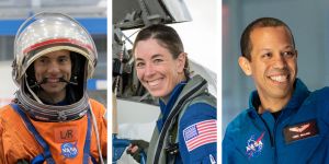 Three individual portraits of astronauts appear side by side. From left, Marcos Berrios in an orange spacesuit and helmet; Christina Birch in a blue flightsuit with a jet cockpit just visible behind her; and Christopher Williams in a blue flightsuit.