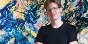 A portrait of Blake Brasher ’03 is silhouetted over an image of one of his artworks.