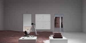Image from the Misalignments exhibition shows a white room with a robotic arm and clay covering half the floor