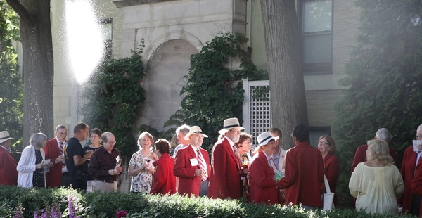 group of 50th reunion alumni chatting outside in red jackets