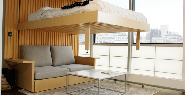 Bed lowering from the ceiling over a couch 