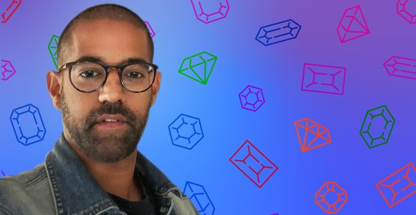 Vikas Sodhani headshot silhouetted against a blue background with gem shapes.